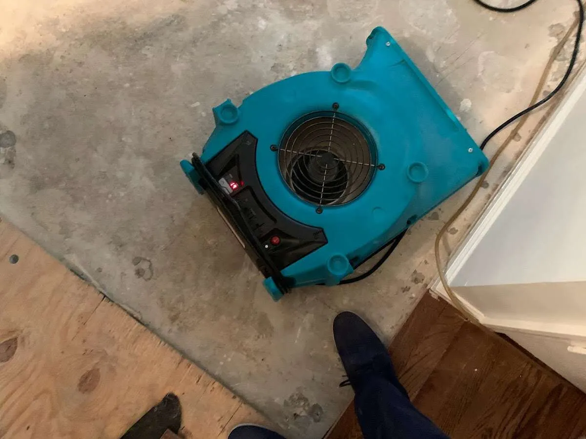 Air mover drying subfloor during Commercial Water Damage Restoration in Manhattan